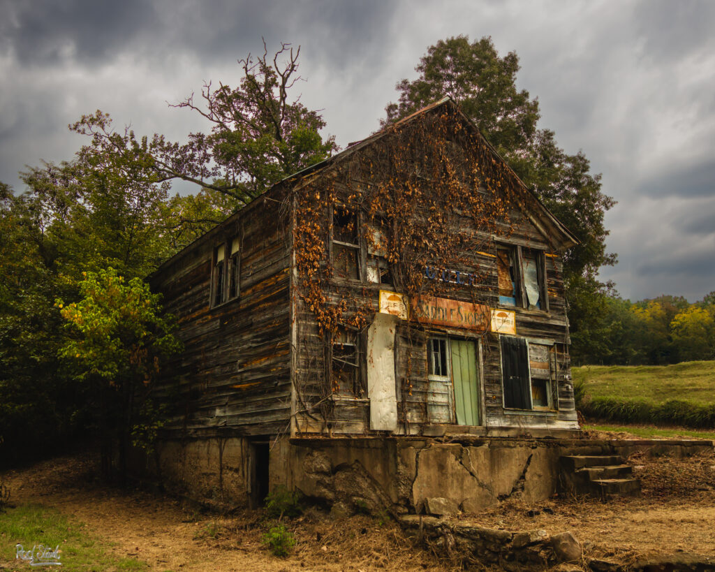 100-year-old store in the Ozarks in disrepair with a stormy sky