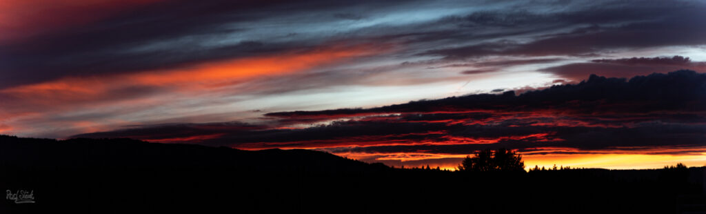 Sunset in Idaho with bands of red, blue, and yellow